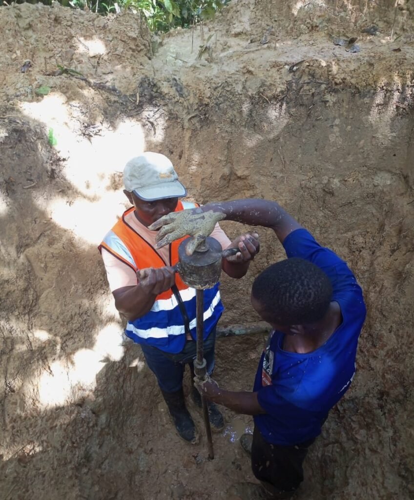 SELA engineer recording DCP readings in a trial pit, Gehwee Junction – Gbedin Falls access road, Nimba County
