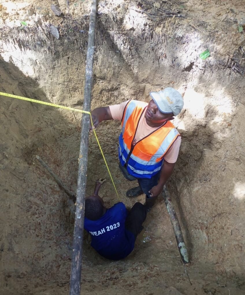 Measuring trial pit depth before disturbed soil sample collection, Gehwee Junction – Gbedin Falls access road, Nimba County